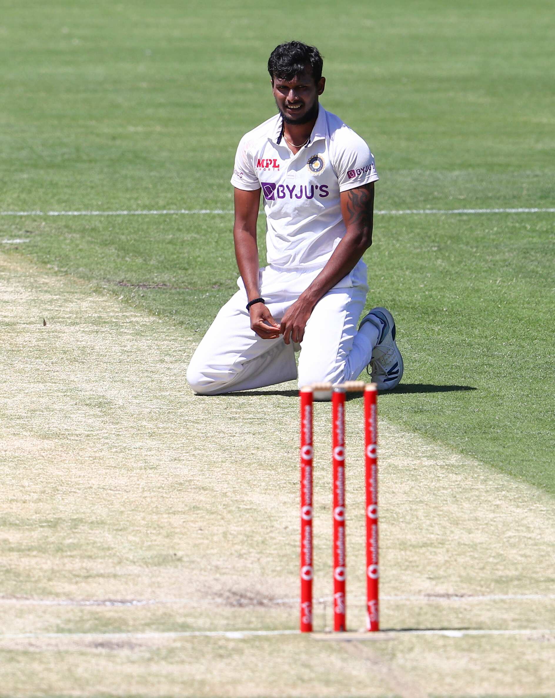 Thangarasu Natarajan of India rests on the pitch during the second day of the fourth India-Australia cricket test in Gabba, Brisbane, Australia, on Saturday, Jan. 16, 2021. (AP Photo / Tertius Pickard) (AP)