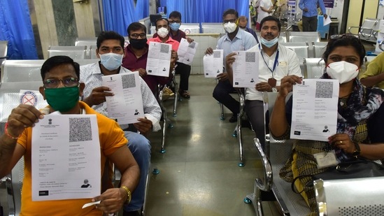 BMC medical staff Aruna Chavan (R) along with other vaccine beneficiaries show their provisional certificate for Covid-19 vaccination (1st dose) in an observation room at King Edward Memorial Hospital (KEM), Parel East, in Mumbai on January 19. Maharashtra health minister Rajesh Tope declared to launch an information, education and communication (IEC) drive to counsel health workers to improve the turnout.(Anshuman Poyrekar / HT Photo)