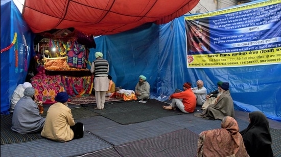 Farmers offering prayer at makeshift a gurdwara at Tikri border during their protest against farm laws, in New Delhi on Thursday. (ANI) Farmers offering prayer at makeshift a gurdwara at Tikri border during their protest against farm laws, in New Delhi on Thursday. (ANI)