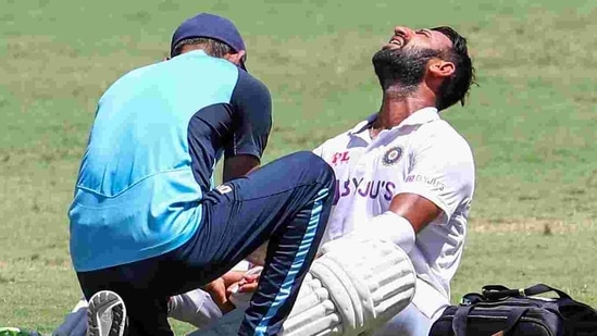 India's Cheteshwar Pujara reacts as he receives treatment after he is hit while batting during play on the final day of the fourth cricket test between India and Australia at the Gabba.(AP) India's Cheteshwar Pujara reacts as he receives treatment after he is hit while batting during play on the final day of the fourth cricket test between India and Australia at the Gabba.(AP)