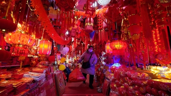 A vendor wearing a mask to protect from the coronavirus walks through her store of Chinese New Year decorations in Wuhan in central China's Hubei province on Friday, Jan. 22, 2021. Life appears to be back to normal on the eve of the anniversary of the 76-day lockdown in the central Chinese city where the coronavirus was first detected. (AP) A vendor wearing a mask to protect from the coronavirus walks through her store of Chinese New Year decorations in Wuhan in central China's Hubei province on Friday, Jan. 22, 2021. Life appears to be back to normal on the eve of the anniversary of the 76-day lockdown in the central Chinese city where the coronavirus was first detected. (AP)
