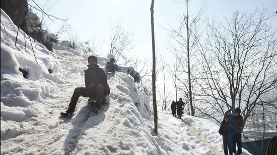 Youngsters enjoy the snow on a hilltop after heavy snowfall, on the outskirts of Srinagar on January 19. (File photo)