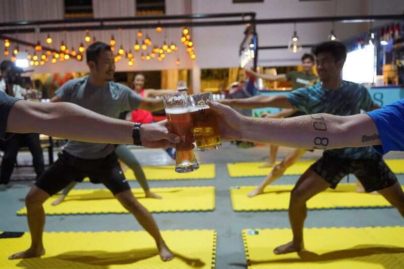 People participate in a beer yoga session, as the country eases the coronavirus disease (COVID-19) restrictions, at a craft brewery in Phnom Penh, Cambodia. (REUTERS)