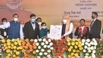 Prime Minister Narendra Modi distributes 'Land Patta' to a woman during a public meeting, at Jerenga Pathar in Sivasagar District of Assam. (PTI Photo) Prime Minister Narendra Modi distributes 'Land Patta' to a woman during a public meeting, at Jerenga Pathar in Sivasagar District of Assam. (PTI Photo)