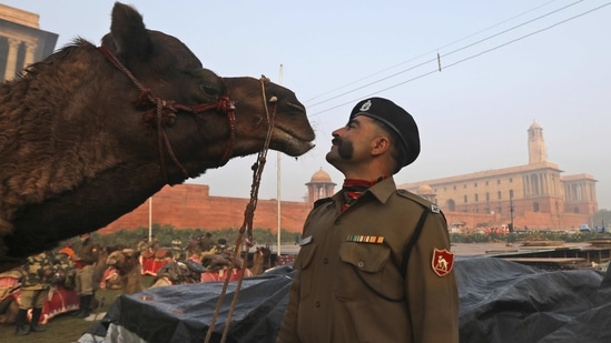 A Border Security Force soldier stands with his camel in between practice for the upcoming Republic Day parade in New Delhi, on January 21.(Manish Swarup / AP)