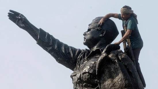 A worker paints Netaji Subhas Chandra Bose's statue ahead of his birth anniversary celebrations in Kolkata on Thursday. (ANI Photo)