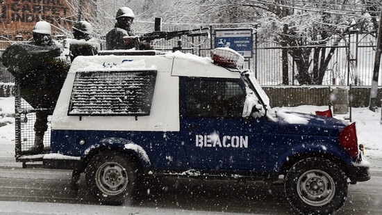 Security personnel keep vigil during fresh snowfall in Srinagar on Saturday. (ANI Photo) Security personnel keep vigil during fresh snowfall in Srinagar on Saturday. (ANI Photo)