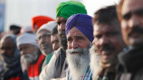 Farmers listen to their leader as they continue to block highway leading to Delhi in protest against new farm laws, at Delhi-Uttar Pradesh border, India,(AP) Farmers listen to their leader as they continue to block highway leading to Delhi in protest against new farm laws, at Delhi-Uttar Pradesh border, India,(AP)