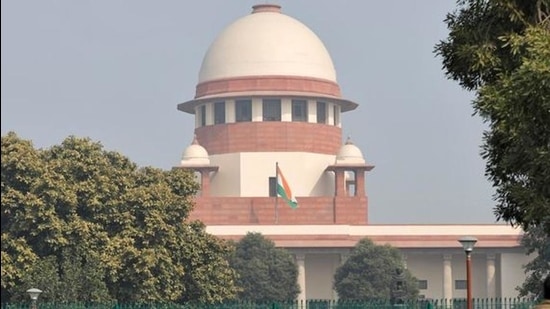 Television journalists are seen outside the premises of the Supreme Court in New Delhi, India, on Friday. (REUTERS)