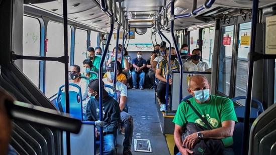 A man sings on a bus in Cali, Colombia, on January 22, 2021, amid the COVID-19 pandemic. - Colombia reached 50,000 deaths from COVID-19 after ten and a half months of pandemic on Thursday, as the country is experiencing a second wave of infections that has hospitals on the brink of collapse. (Photo by Luis ROBAYO / AFP)(AFP) A man sings on a bus in Cali, Colombia, on January 22, 2021, amid the COVID-19 pandemic. - Colombia reached 50,000 deaths from COVID-19 after ten and a half months of pandemic on Thursday, as the country is experiencing a second wave of infections that has hospitals on the brink of collapse. (Photo by Luis ROBAYO / AFP)(AFP)