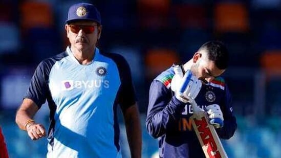 India's captain Virat Kohli, right, and coach Ravi Shastri prepare for their T20 international cricket match against Australia at Manuka Oval, in Canberra, Australia.(AP)