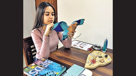 Niharika Rajput at work on a paper sculpture of the Indian Roller.