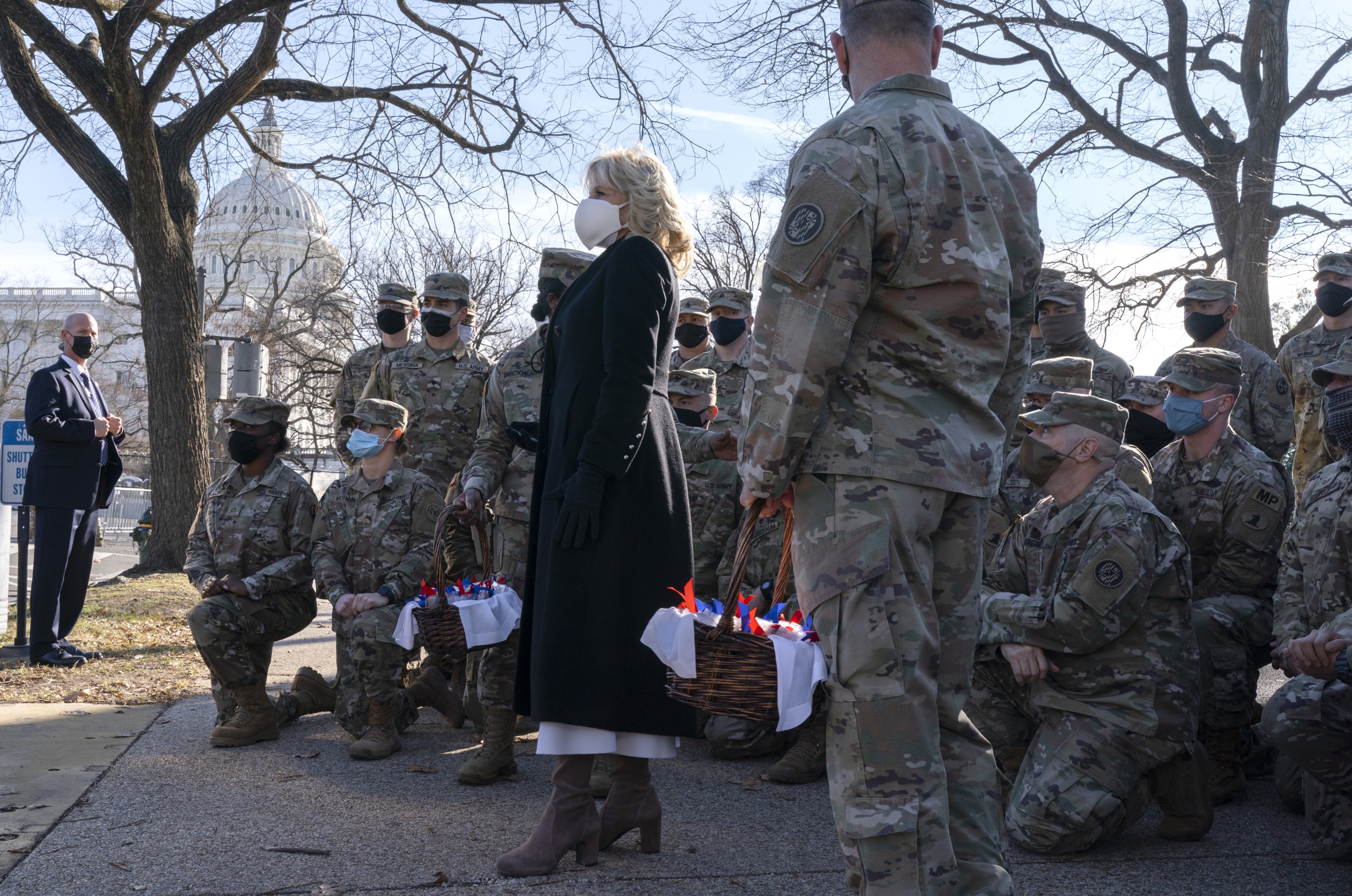 First lady Jill Biden poses for a photograph with members of the National Guard, after surprising them with chocolate chip cookies(AP Photo) First lady Jill Biden poses for a photograph with members of the National Guard, after surprising them with chocolate chip cookies(AP Photo)