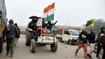 A farmer drives a tractor with the national flag as farmers prepare for a tractor rally on January 26, at Singhu Border near Delhi on Sunday. (ANI Photo) A farmer drives a tractor with the national flag as farmers prepare for a tractor rally on January 26, at Singhu Border near Delhi on Sunday. (ANI Photo)