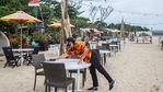 An employee wearing a protective mask cleans a table at a restaurant in Kedonganan, Bali, Indonesia,. (Bloomberg) An employee wearing a protective mask cleans a table at a restaurant in Kedonganan, Bali, Indonesia,. (Bloomberg)
