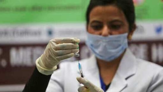 A health worker prepares to administer a Covid-19 vaccine to a hospital staff at a government Hospital in Jammu, India. (AP) A health worker prepares to administer a Covid-19 vaccine to a hospital staff at a government Hospital in Jammu, India. (AP)