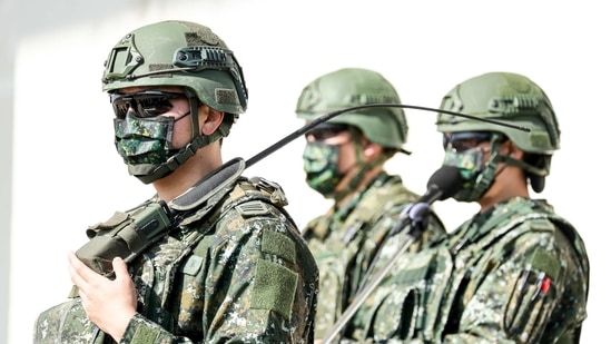Members of Taiwan's armed forces wear protective masks during a military exercise in Hukou, Hsinchu County, Taiwan, on Tuesday, Jan. 19, 2021. China's state-run media called for retaliation after the Trump administration removed decades-old restrictions on interactions with Taiwan officials just days before President-elect Joe Biden takes office, one of its biggest moves yet to reshape U.S. ties with the Asian democracy. Photographer: I-Hwa Cheng/Bloomberg(Bloomberg) Members of Taiwan's armed forces wear protective masks during a military exercise in Hukou, Hsinchu County, Taiwan, on Tuesday, Jan. 19, 2021. China's state-run media called for retaliation after the Trump administration removed decades-old restrictions on interactions with Taiwan officials just days before President-elect Joe Biden takes office, one of its biggest moves yet to reshape U.S. ties with the Asian democracy. Photographer: I-Hwa Cheng/Bloomberg(Bloomberg)