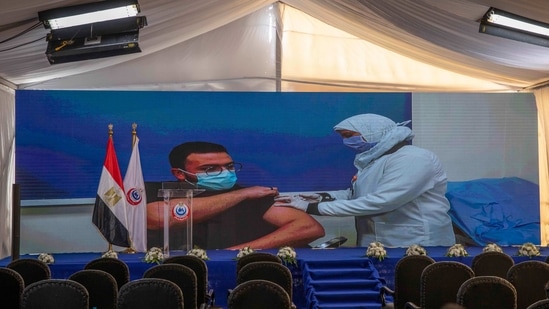 Dr. Abdel Menoim Selim, is shown on a live screen receiving the Sinopharm Covid-19 vaccine, ahead of a press conference, at the Abu Khalifa Hospital in Ismailia, 120 kilometers (75 miles) east of Cairo, Egypt,(AP) Dr. Abdel Menoim Selim, is shown on a live screen receiving the Sinopharm Covid-19 vaccine, ahead of a press conference, at the Abu Khalifa Hospital in Ismailia, 120 kilometers (75 miles) east of Cairo, Egypt,(AP)