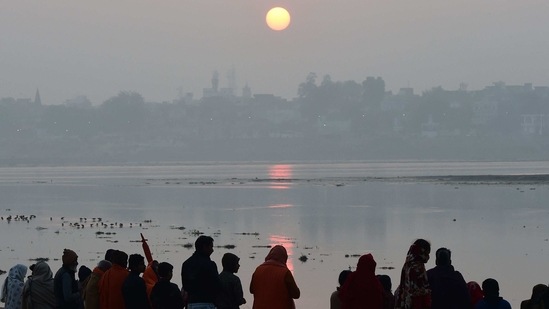 People praying at Sangam, the confluence of rivers Ganga, Yamuna and mythical Saraswati during Magh Mela in Allahabad on January 23. As per the IMD's classification, cold wave conditions in northern plains of India are declared when the minimum temperature falls below 4 degrees Celsius.(Sanjay Kanojia / AFP)