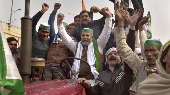BKU spokesperson Rakesh Tikait along with farmers raises slogans during their ongoing agitation against Centre's farm reform laws at Ghazipur border, (PTI) BKU spokesperson Rakesh Tikait along with farmers raises slogans during their ongoing agitation against Centre's farm reform laws at Ghazipur border, (PTI)