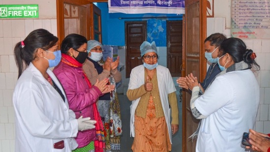 Mirzapur: Health workers applaud a medic after she took the first dose of Covishield vaccine during the COVID-19 vaccination drive, at District Woman Hospital in Mirzapur, Friday, Jan. 22, 2021. (PTI Photo)(PTI01_22_2021_000060B) (PTI) Mirzapur: Health workers applaud a medic after she took the first dose of Covishield vaccine during the COVID-19 vaccination drive, at District Woman Hospital in Mirzapur, Friday, Jan. 22, 2021. (PTI Photo)(PTI01_22_2021_000060B) (PTI)