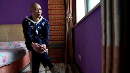 Wuhan resident Zhu Tao speaks during an interview near boxes of instant noodles stacked in his bedroom at home in Wuhan in central China's Hubei province. (AP)