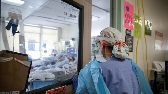 A nurse anesthetist enters a room to care for Covid-19 patients in a makeshift ICU at Harbor-UCLA Medical Center on January 21 in Torrance, California. Health officials worry that a more contagious South African variant may reduce the efficacy of current vaccines and shows resistance to three antibody treatments developed for patients, Reuters reported.(Mario Tama / Getty Images / AFP)