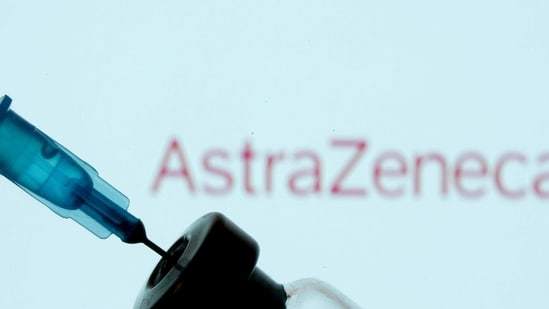 A vial and syringe are seen in front of a displayed AstraZeneca logo.(Reuters)