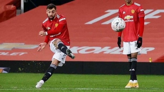 Manchester United's Bruno Fernandes scores their third goal from a free-kick. (Pool via REUTERS)