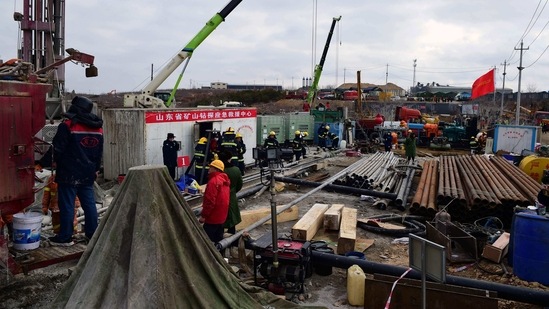 This photo taken on January 20, 2021 shows members of a rescue team working at the site of a gold mine explosion where 22 miners are trapped underground in Qixia, in eastern China's Shandong province. (Photo by STR / various sources / AFP) / China OUT(AFP) This photo taken on January 20, 2021 shows members of a rescue team working at the site of a gold mine explosion where 22 miners are trapped underground in Qixia, in eastern China's Shandong province. (Photo by STR / various sources / AFP) / China OUT(AFP)
