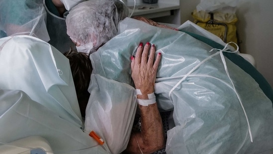 Nurses lift a Covid-19 patient at the Pasteur hospital resuscitation unit in Colmar, France, on January 22. To monitor changes to the coronavirus, scientists must sequence its genetic code to catalogue mutations as they emerge. But so few countries are conducting and sharing surveillance that experts are as worried about the mutations they cannot see as those they can.(Sebastien Bozon / AFP)