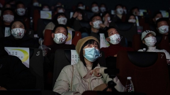 Moviegoers viewing the film "Days and Nights in Wuhan" at a theatre in Wuhan, China on January 23. China, this weekend, marked the anniversary of the world's first coronavirus lockdown in the central city of Wuhan, and is facing the worst wave of local cases since March last year.(Getty Images)