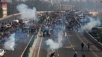 A protesting farmer hurls back a tear gas shell towards police as they march to the capital breaking police barricades during Republic Day celebrations in New Delhi, on Tuesday.(AP Photo) A protesting farmer hurls back a tear gas shell towards police as they march to the capital breaking police barricades during Republic Day celebrations in New Delhi, on Tuesday.(AP Photo)