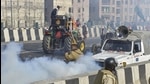 Police use tear gas to disperse farmers attempting to break barricades at Ghazipur border for their tractor rally on Tuesday, January 26. (PTI) Police use tear gas to disperse farmers attempting to break barricades at Ghazipur border for their tractor rally on Tuesday, January 26. (PTI)