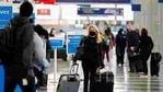 A traveler wears a mask as she walks through Terminal 3 at O'Hare International Airport in Chicago.(AP File Photo ) A traveler wears a mask as she walks through Terminal 3 at O'Hare International Airport in Chicago.(AP File Photo )