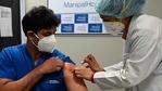A medical worker (R) inoculates a medical staff with a Covid-19 coronavirus vaccine.(AP) A medical worker (R) inoculates a medical staff with a Covid-19 coronavirus vaccine.(AP)