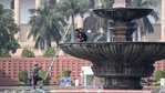 Men work near the Parliament in New Delhi. (AFP) Men work near the Parliament in New Delhi. (AFP)