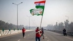 A protesting farmer waves an Indian flag and a farmer union flag as he marches with others to the capital breaking police barricades during Republic Day celebrations in New Delhi.(AP) A protesting farmer waves an Indian flag and a farmer union flag as he marches with others to the capital breaking police barricades during Republic Day celebrations in New Delhi.(AP)