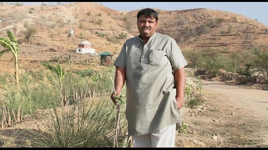 Shyam Sunder Paliwal shows the plantation done at the Pipalantri Model Based Pasture land Development at Gram Panchayat Tasol, at Rajsamand district, Rajasthan. (HT Archive)