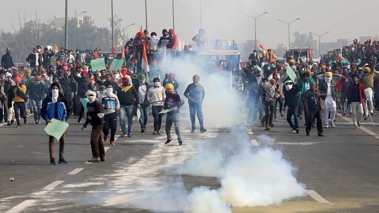 Smoke billows from a tear gas shell during a tractor rally by farmers to protest against farm laws on Republic Day at Ghazipur border near Delhi(Reuters) Smoke billows from a tear gas shell during a tractor rally by farmers to protest against farm laws on Republic Day at Ghazipur border near Delhi(Reuters)