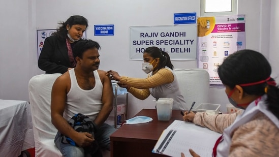 A health worker receives a Covishield coronavirus vaccine jab at Rajiv Gandhi Super Speciality Hospital in New Delhi. (Amal KS/ Hindustan Times)
