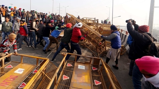 Protesting farmers remove the barricades after breaching the routes during their tractor rally at Ghazipur border, in New Delhi(ANI Photo) Protesting farmers remove the barricades after breaching the routes during their tractor rally at Ghazipur border, in New Delhi(ANI Photo)