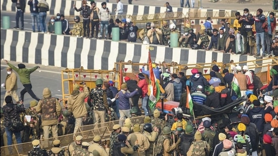 Farmers break the police barricades at the Ghazipur border as move towards Akshardham during their tractor rally on Republic Day in New Delhi, Tuesday, January 26. (PTi) Farmers break the police barricades at the Ghazipur border as move towards Akshardham during their tractor rally on Republic Day in New Delhi, Tuesday, January 26. (PTi)