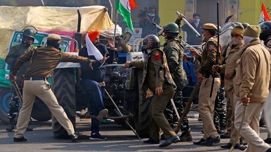 Police officers scuffle with a demonstrator during the tractor rally in New Delhi on January 26. Violence was reported during the rally from Delhi’s ITO.(Adnan Abidi / REUTERS)