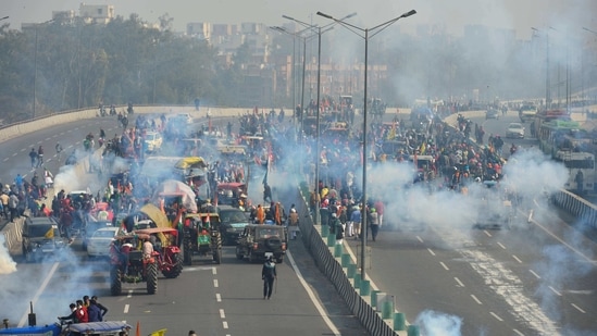 New Delhi: Police fire teargas shells to disperse protesting farmers who were attempting to break barricades at Ghazipur border during their 'tractor march' on Republic Day, in New Delhi, Tuesday, Jan. 26, 2021. (PTI Photo/Ravi Choudhary)(PTI01_26_2021_000463B)(PTI) New Delhi: Police fire teargas shells to disperse protesting farmers who were attempting to break barricades at Ghazipur border during their 'tractor march' on Republic Day, in New Delhi, Tuesday, Jan. 26, 2021. (PTI Photo/Ravi Choudhary)(PTI01_26_2021_000463B)(PTI)