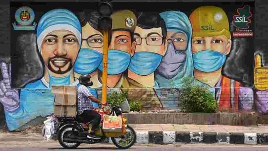 A motorist passes by a mural of frontline workers against coronavirus at RK Puram in New Delhi on July 25. Delhi’s Covid-19 recoveries have outstripped new cases on almost all days this month barring a few exceptions, after ramped-up containment and testing efforts over the past month or so. (Sanchit Khanna / HT Photo) A motorist passes by a mural of frontline workers against coronavirus at RK Puram in New Delhi on July 25. Delhi’s Covid-19 recoveries have outstripped new cases on almost all days this month barring a few exceptions, after ramped-up containment and testing efforts over the past month or so. (Sanchit Khanna / HT Photo)