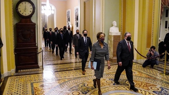 Clerk of the House Cheryl Johnson along with acting House Sergeant-at-Arms Tim Blodgett lead the Democratic House impeachment managers as they walk through the Capitol Hill to deliver to the Senate the article of impeachment alleging incitement of insurrection against former president Donald Trump, in Washington, DC on January 25, 2021. (AP) Clerk of the House Cheryl Johnson along with acting House Sergeant-at-Arms Tim Blodgett lead the Democratic House impeachment managers as they walk through the Capitol Hill to deliver to the Senate the article of impeachment alleging incitement of insurrection against former president Donald Trump, in Washington, DC on January 25, 2021. (AP)