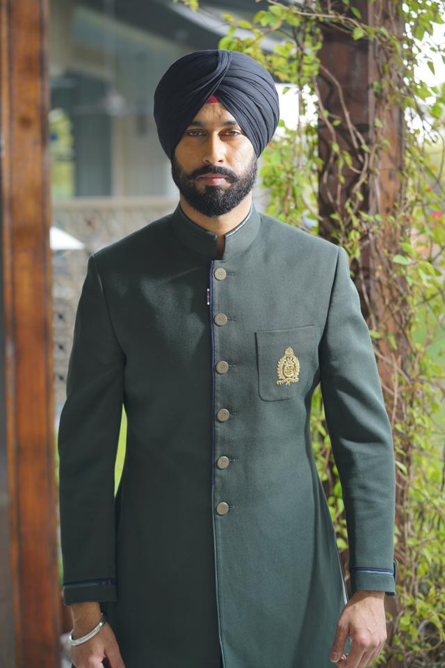 Manpreet Singh’s elegant bandhgala in olive green, paired with a matching turban, stands out. Layer your look with vibrant shawls in similar shades. (Photo: Ichit Anand) Manpreet Singh’s elegant bandhgala in olive green, paired with a matching turban, stands out. Layer your look with vibrant shawls in similar shades. (Photo: Ichit Anand)