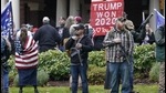 Two men stand armed with guns during a protest supporting Donald Trump and against the counting of electoral votes on January 6. (AP file) Two men stand armed with guns during a protest supporting Donald Trump and against the counting of electoral votes on January 6. (AP file)