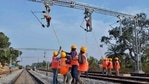 Workers on contract for Indian Railways, erect infrastructure for drawing electric cable lines over railway tracks for use by locomotives on the outskirts of Bangalore. (AFP) Workers on contract for Indian Railways, erect infrastructure for drawing electric cable lines over railway tracks for use by locomotives on the outskirts of Bangalore. (AFP)